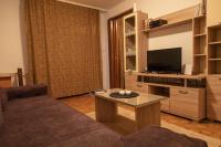 a living room with a couch and a tv at Apartman TWO 