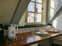 a kitchen counter with a coffee maker and a window at Suite Toussaint - Calme &amp; Authentique in Angers