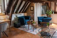 a living room with blue chairs and a table at Suite Toussaint - Calme &amp; Authentique in Angers