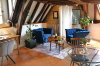 a living room with blue chairs and a table at Suite Toussaint - Calme &amp; Authentique in Angers