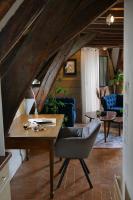 an attic room with a desk and a chair at Suite Toussaint - Calme &amp; Authentique in Angers