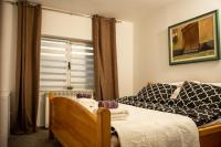 a bedroom with a bed and a window at Guest House Lejla in Travnik