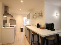 a kitchen with a counter with stools in it at Appartement La Bourboule, 3 pièces, 4 personnes - FR-1-608-261 in La Bourboule