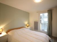 a bedroom with a large bed and a window at Appartement La Bourboule, 3 pièces, 4 personnes - FR-1-608-261 in La Bourboule