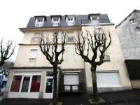 a building with two trees in front of it at Appartement La Bourboule, 3 pièces, 4 personnes - FR-1-608-261 in La Bourboule