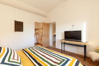 a bedroom with a bed and a flat screen tv at La Petite Bastide in Sanary-sur-Mer