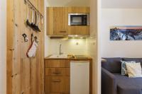a small kitchen with a sink and a microwave at Chamonix Sud - Forclaz 304 - Happy Rentals in Chamonix