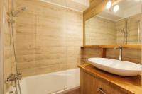 a bathroom with a white sink and a shower at Chamonix Sud - Forclaz 304 - Happy Rentals in Chamonix