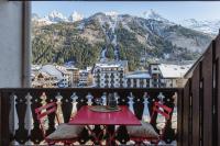 a table on a balcony with a view of mountains at Chamonix Sud - Forclaz 304 - Happy Rentals in Chamonix