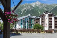 a group of buildings with mountains in the background at Chamonix Sud - Forclaz 304 - Happy Rentals in Chamonix