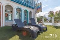 two chairs sitting on a lawn in front of a house at Sweet Rainbow B&amp;B in Hualien City