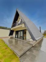 a house with a gambrel roof with a patio at Villa Anemar in Blidinje