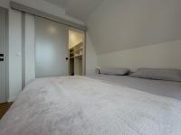 a white bedroom with two beds and a closet at Villa Anemar in Blidinje