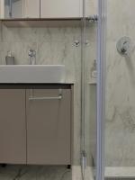 a white bathroom with a sink and a shower at Villa Anemar in Blidinje