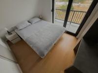 a bed in a room with a large window at Villa Anemar in Blidinje