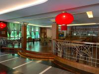 a restaurant with red lamps and a dining room at King&#39;s Resort &amp; Spa in Tai&#39;an