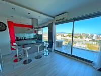 a kitchen with a bar with a view of a city at Le Chaville in Cagnes-sur-Mer