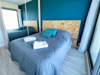 a bedroom with a bed with towels on it at Le Chaville in Cagnes-sur-Mer