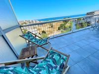a balcony with two chairs and a view of the ocean at Le Chaville in Cagnes-sur-Mer