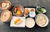 a tray filled with different types of food on a table at Jiangnan House Changyuan in Suzhou