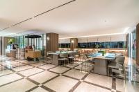 a restaurant with tables and chairs and windows at SSAW Boutique Hotel Shanghai Bund in Shanghai