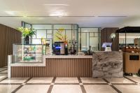 a lobby of a store with a counter with flowers at SSAW Boutique Hotel Shanghai Bund in Shanghai