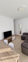 A television and/or entertainment centre at Apartamentos Gran Socaire de Noja