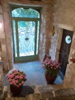 a doorway with a green door and two potted plants at L&#39;Armandière, maison de caractère où règne calme et sérénité. in Pézenes-les-Mines