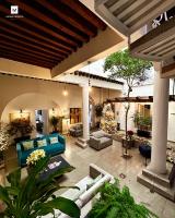an outdoor living room with blue couches and plants at M Hoteles Concepto in Morelia