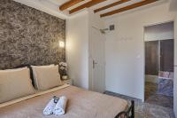 a bedroom with a bed with two towels on it at Hotel Petit Vix in Paris