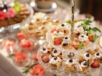 a table with several cakes and fruit on plates at HOTEL StDaniel in Štanjel