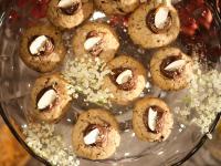 a glass bowl filled with chocolatecovered donuts on a table at HOTEL StDaniel in Štanjel