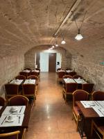 a dining room with tables and chairs and a brick wall at 121 Paris Hotel in Paris