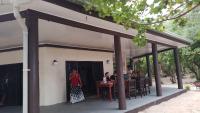 un grupo de personas sentadas en mesas fuera de un edificio en Yasawa Long Beach Hideout Resort, en Vuake