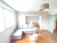 a living room with a white couch and two tables at Logement entier : appartement - Brest in Brest