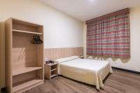 a small bedroom with a bed and a window at DELPLAZA Timbiras São Paulo in São Paulo