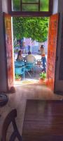 a group of people sitting at a table through an open door at Pousada Praia Maria in Praia