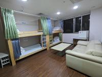 a living room with a couch and a table at Hey Bear Capsule Hotel in Taipei