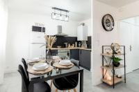 a kitchen with a dining table with black chairs at Grand &amp; Lumineux T2 au Coeur de Monplaisir • Métro à 2’ • Parking Privé in Lyon