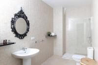 a bathroom with a sink and a mirror and a toilet at Palacio de Luja in El Puerto de Santa María