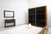 a bedroom with a bed with a dresser and a mirror at Palacio de Luja in El Puerto de Santa María