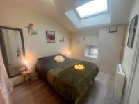 a bedroom with a bed and a skylight at Le Repaire du p&#39;tit Chartreux by LPNL in Rives