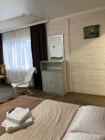 a hotel room with a bed and a desk and a window at Guest house Shulc in Mizhhirya