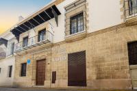 a brick building with two balconies on top of it at Palacio de Luja in El Puerto de Santa María