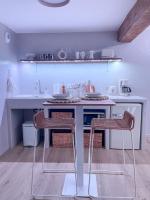a kitchen with two chairs and a counter in a room at À la folie - Loft &amp; Spa in Montrevault