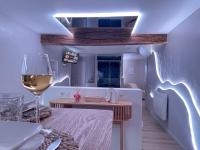 a room with a table and a glass of wine at À la folie - Loft &amp; Spa in Montrevault