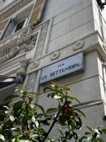 a street sign on the side of a building at Hotel Genova Liberty in Genoa