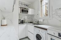 a white kitchen with a sink and a dishwasher at Résidence AURMAT - Appart - Hôtel - Boulogne - Paris in Boulogne-Billancourt