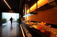 a man walking past a buffet line in a restaurant at Olivia Balmes Hotel in Barcelona