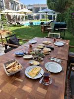 a wooden table with plates of food on it at Malta Hotel Bodrum in Bodrum City